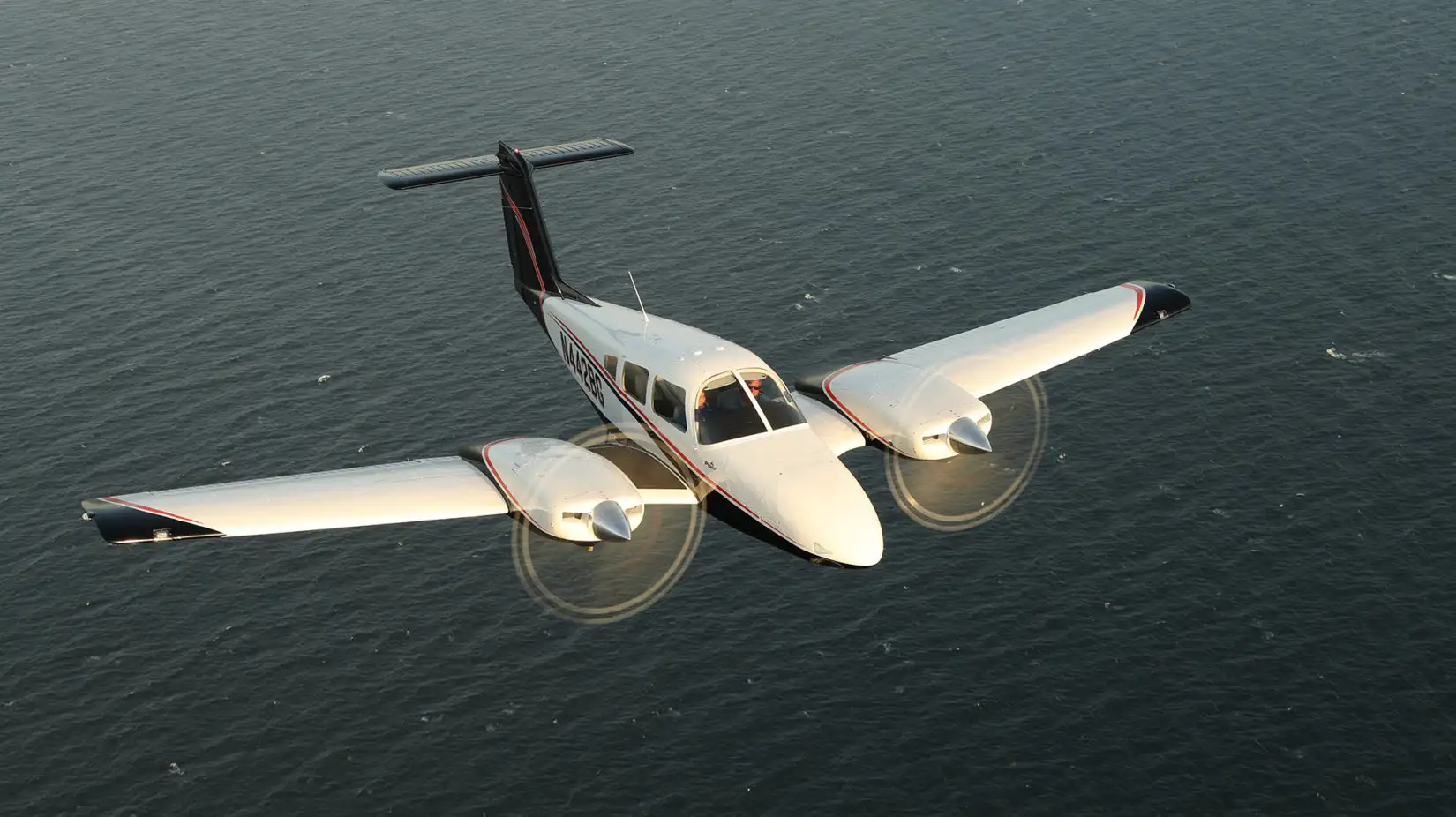 Picture of a multi-engine plane flying, sourced from piper.com