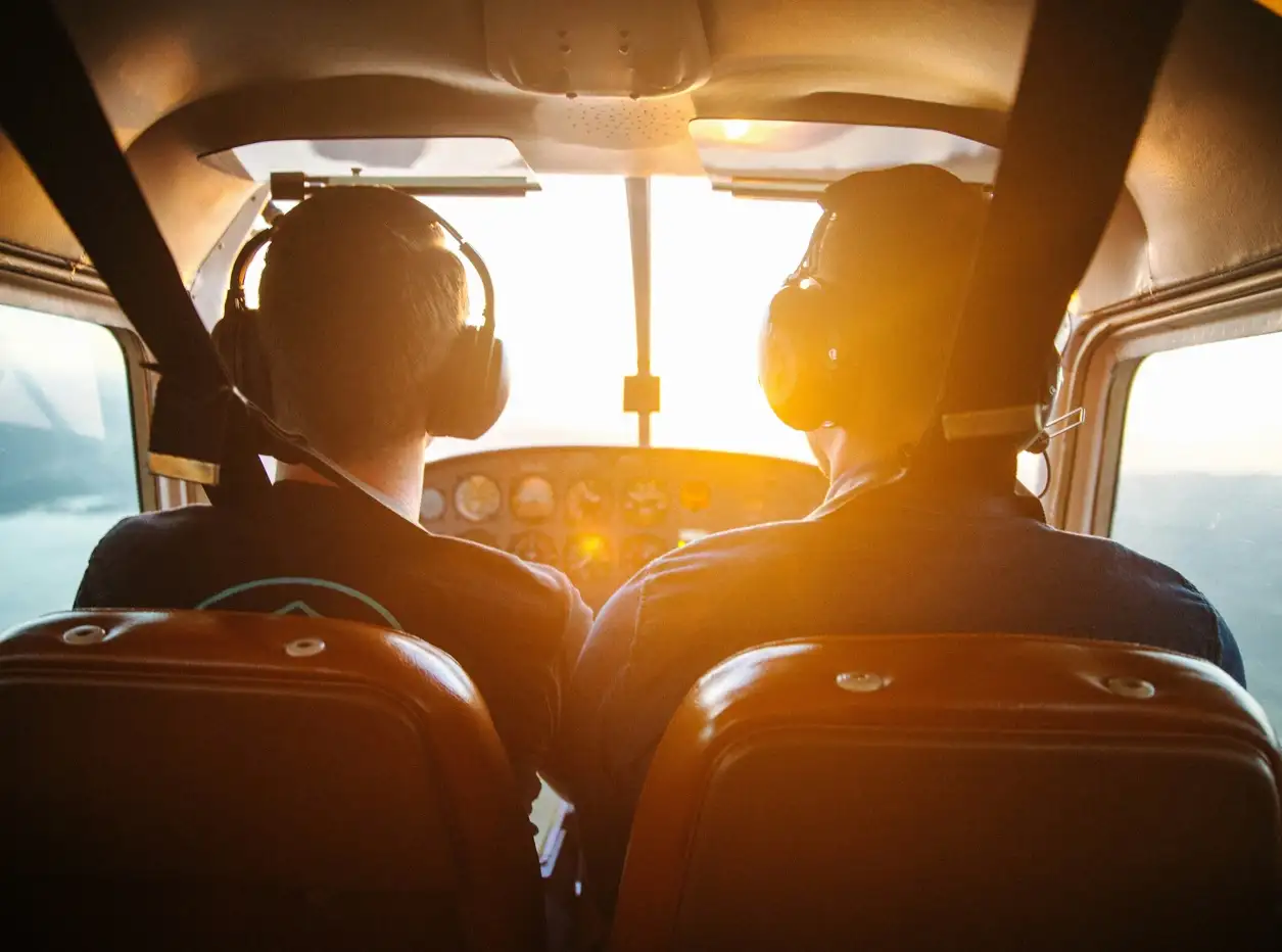 Picture of two people flying an airplane, sourced from unsplash, piture by Avel Chuklanov