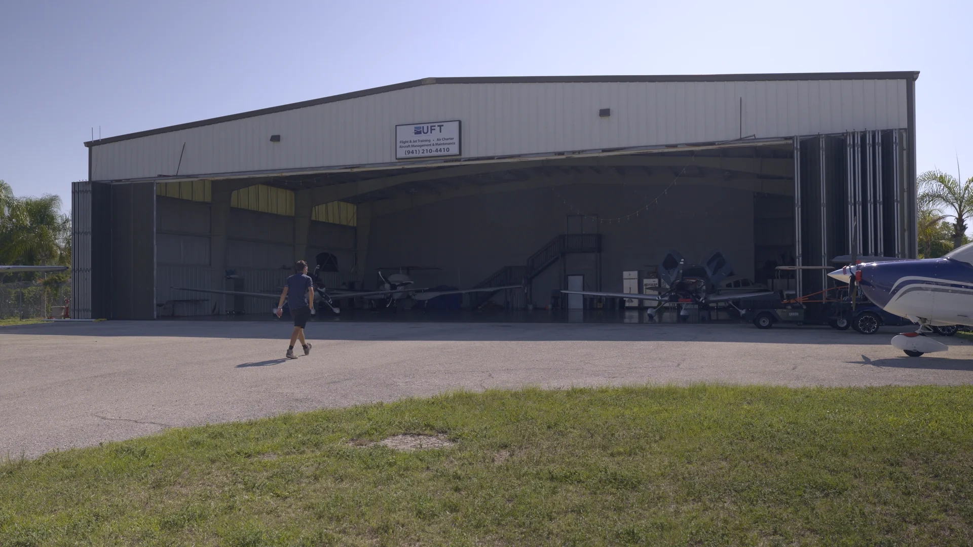 Man walking up to Universal Flight Training hangar in Sarasota, Florida