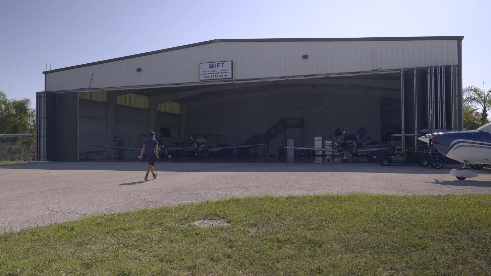 Man walking up to Universal Flight Training hangar in Sarasota, Florida