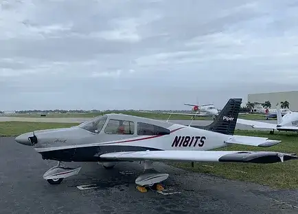 Universal Flight Training Piper Archer II parked at the airport