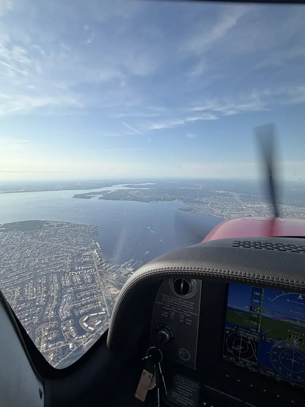 Plane flying over city seen from cockpit