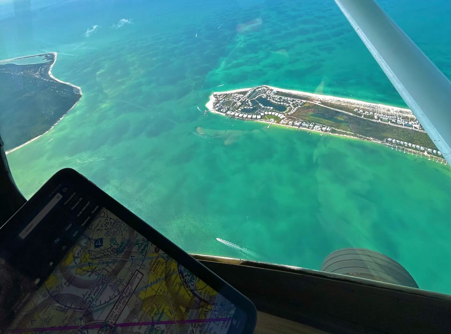 Plane flying over sea seen from cockpit window