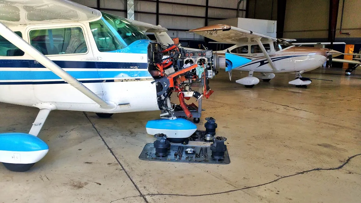 Universal Flight Training aircraft technician inspecting engine components