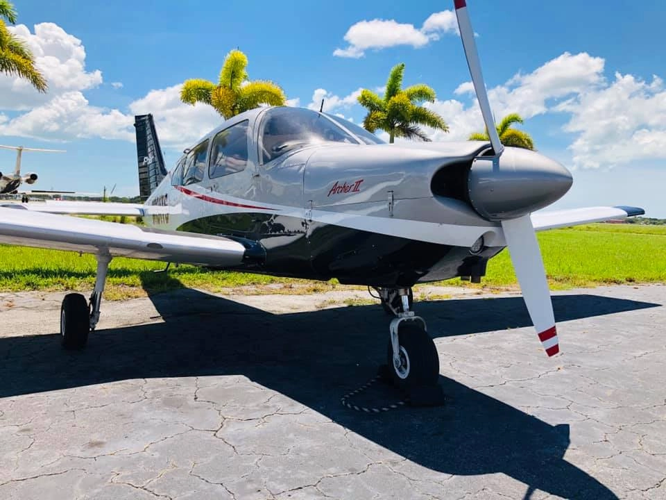 Universal Flight Training Piper Archer II parked at the airport