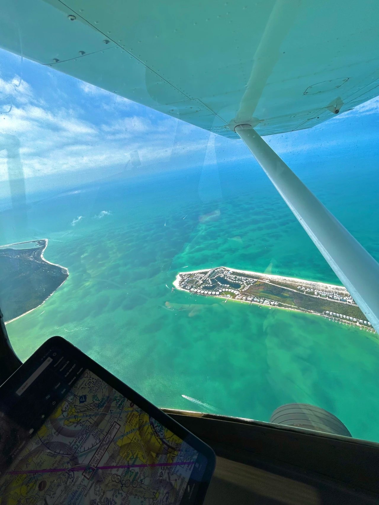 Plane flying over sea seen from cockpit window