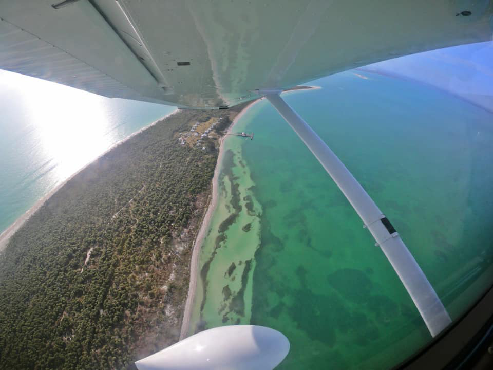Siesta key beach seen from the cockpit window of a flying plane
